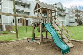 Atlanta apartment for rent - A green slide is the main feature of this playground.