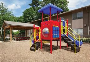 Atlanta apartment for rent - A playground with a red and blue slide and a yellow railing.