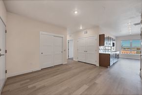 Aurora apartment for rent - A spacious room with light wood flooring and white walls.