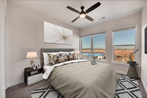 Aurora apartment for rent - A bedroom with a large bed and a ceiling fan.