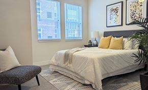 Aurora apartment for rent - a bedroom with a bed and two windows