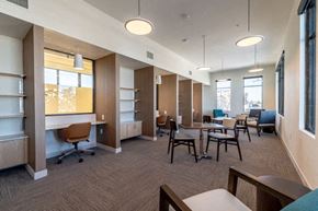 Aurora apartment for rent - A spacious office with a long table and chairs.