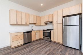 Aurora apartment for rent - A kitchen with wooden cabinets and stainless steel appliances.