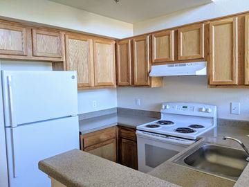 Aurora apartment for rent - an empty kitchen with a stove refrigerator and sink