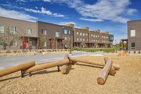 Aurora townhouse for rent - a playground with logs in front of an apartment building