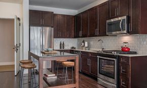 Lake Forest apartment for rent - apartment kitchen with quartz countertops, shaker-style cabinetry, and stainless teel appliances