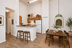 Pensacola apartment for rent - A kitchen with a table and chairs in the middle of the room.