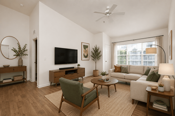 Pensacola apartment for rent - A living room with a green chair and a white couch.