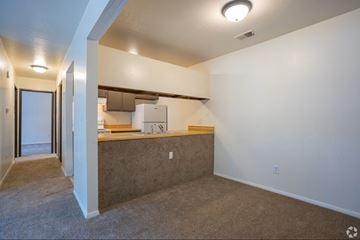 Grand Rapids apartment for rent - A kitchen area with a counter and a refrigerator.