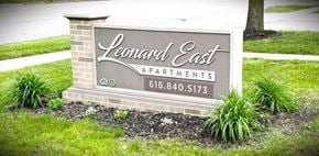 Grand Rapids apartment for rent - A sign for Leonard East Apartments is displayed in front of a tree.