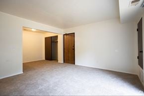 Grand Rapids apartment for rent - A room with a carpeted floor and two wooden doors.
