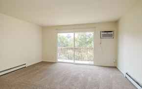 Grand Rapids apartment for rent - A room with a carpeted floor, a sliding glass door, and a window.