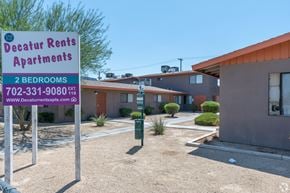 Las Vegas apartment for rent - A sign for Decatur Rents Apartments with a phone number and website listed.