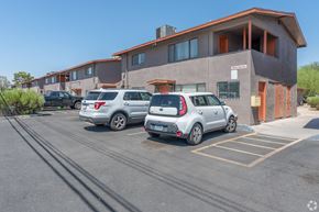 Las Vegas apartment for rent - A parking lot with cars and a building in the background.