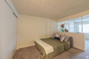 Las Vegas apartment for rent - A bedroom with a bed and a carpeted floor.