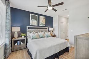 Jacksonville apartment for rent - a bedroom with a bed and a ceiling fan