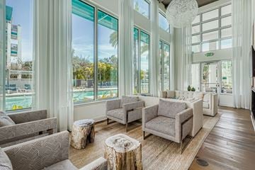 Sarasota apartment for rent - A living room with grey couches and a wooden floor.