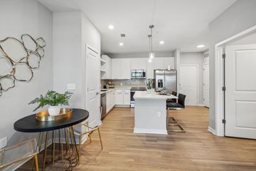 Jacksonville apartment for rent - an open kitchen and living room with a table and chairs