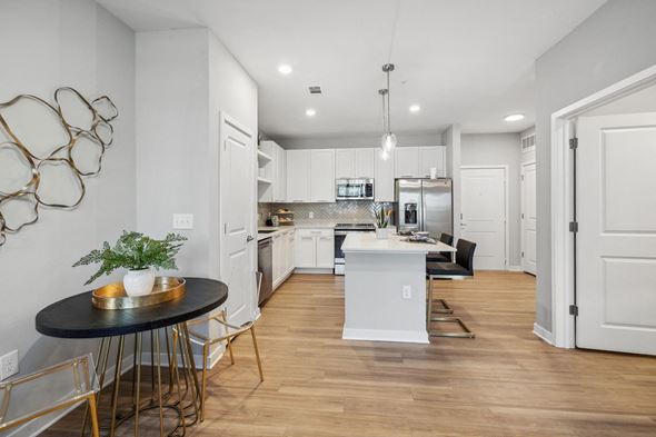 Jacksonville apartment for rent - an open kitchen and living room with a table and chairs