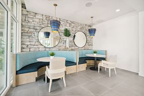 Clearwater apartment for rent - a dining room with tables and chairs and a stone wall