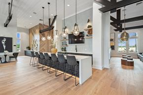 Orlando apartment for rent - a large kitchen with a long island and chairs in front of a white counter top