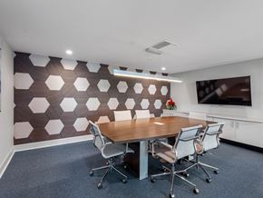 Jupiter apartment for rent - A conference room with a brown and white patterned wall and a wooden table.