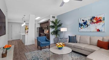 Jupiter apartment for rent - A living room with a blue chair and a white couch.