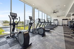 St. Petersburg apartment for rent - A gym with exercise equipment and a view of the outside.