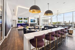St. Petersburg apartment for rent - A modern kitchen with a bar area and a view of the city.
