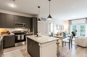 Midlothian apartment for rent - A modern kitchen with dark brown cabinets and a white island.