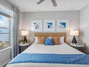 Clearwater apartment for rent - A bedroom with a large bed and a window overlooking a field.