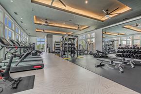 Frederick apartment for rent - a gym with treadmills and other exercise equipment and windows