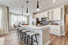 Frederick apartment for rent - a kitchen with a large island with bar stools