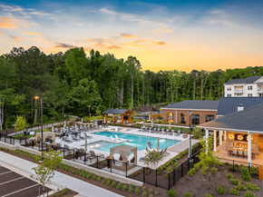 Midlothian apartment for rent - A large outdoor swimming pool surrounded by trees and a building.