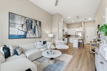 Orlando apartment for rent - A living room with a white couch and a large abstract painting on the wall.