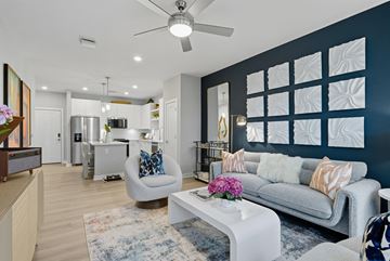 Wesley Chapel apartment for rent - A modern living room with a grey sofa and a white coffee table.