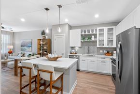Orlando apartment for rent - A modern kitchen with a dining table and chairs.