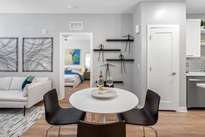 Orlando apartment for rent - A modern dining room with a white table and black chairs.