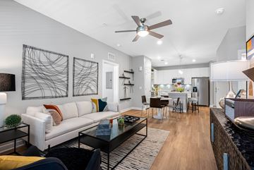 Orlando apartment for rent - A modern living room with a white sofa and a black coffee table.