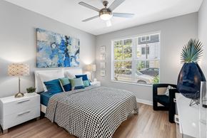 Orlando apartment for rent - A bedroom with a large bed and a ceiling fan.