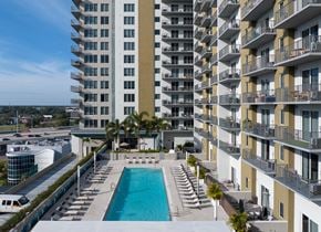 Tampa apartment for rent - a swimming pool in front of an apartment building