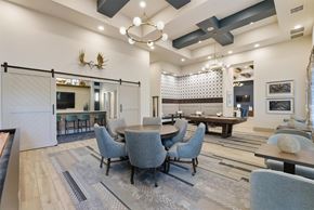 Wesley Chapel apartment for rent - A modern dining room with a large table and grey chairs.