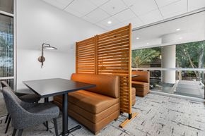 Orlando apartment for rent - A modern dining room with a table, chairs, and a wooden slat partition.