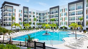 St. Petersburg apartment for rent - A large swimming pool in front of apartment buildings.