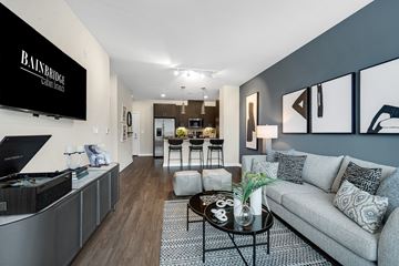 Clarksburg apartment for rent - A modern living room with a grey sofa and a coffee table.