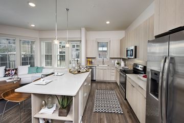 Sarasota apartment for rent - an open kitchen and living room with a large island and stainless steel appliances