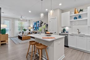 Ponte Vedra apartment for rent - A modern kitchen with white cabinets and a central island.