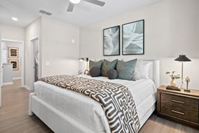 Ponte Vedra apartment for rent - A bedroom with a large bed and a ceiling fan.