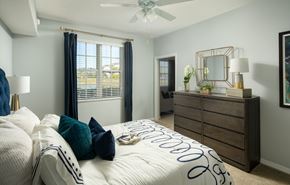 Naples apartment for rent - a bedroom with a large bed and a ceiling fan