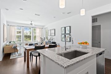 Clermont apartment for rent - A kitchen with a granite countertop and a dining table with chairs.
